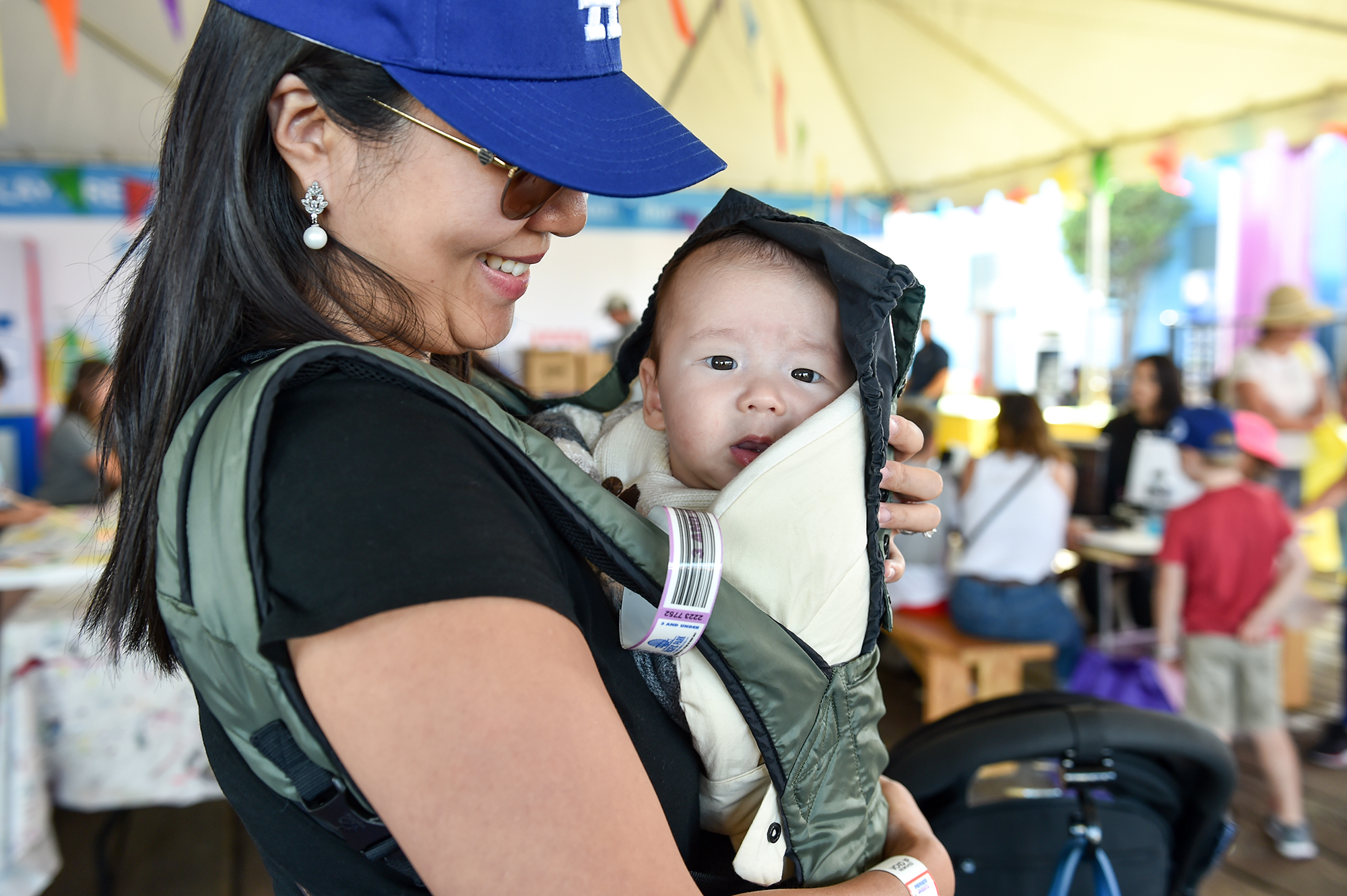 Woman holding a baby at Party on the Pier 2019